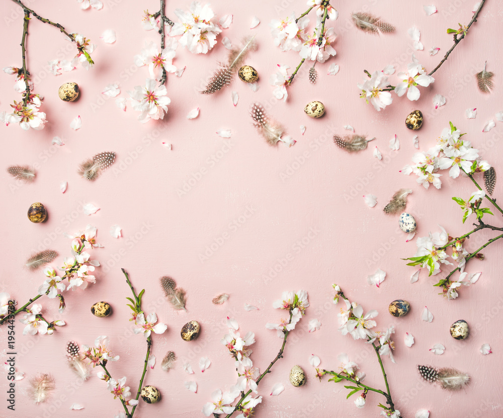 Naklejka premium Easter holiday background. Flat-lay of tender Spring almond blossom flowers on branches, feathers, quail eggs over light pink background, top view, copy space. Greeting card concept