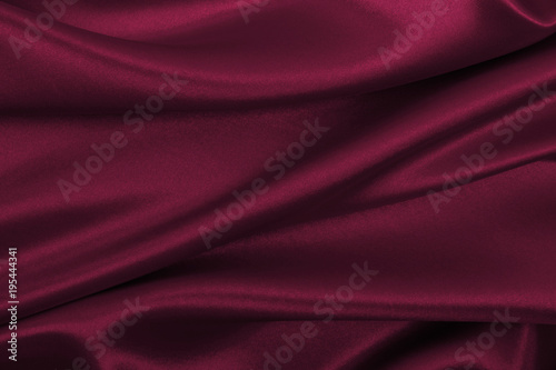 Smooth elegant pink silk or satin luxury cloth texture as abstract background. Luxurious background design photo