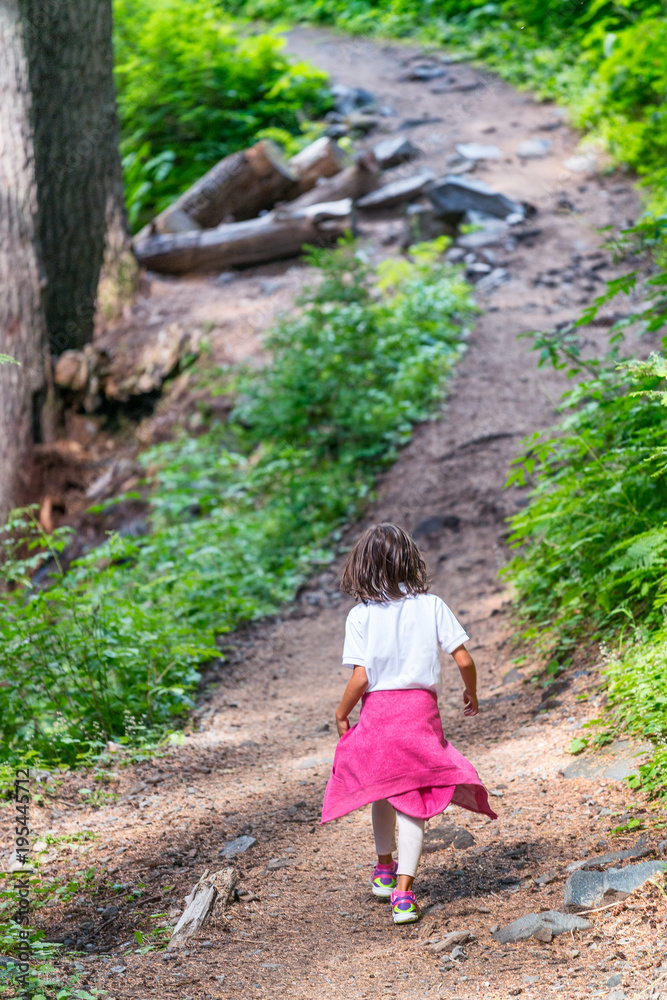 Little girl walking on a mountain trail Little girl walking on a mountain trail