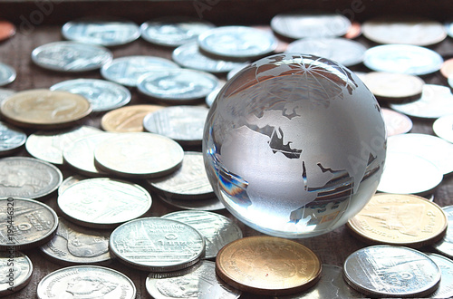 Map world glass on coins , finicial concept. photo