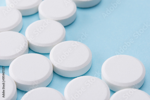 white pills on blue background