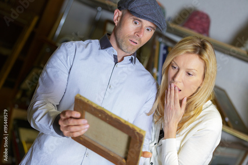 excited emotional woman and man discovered painting