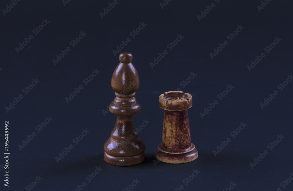 chess officer and rook on a black background chess officer and rook on a black background