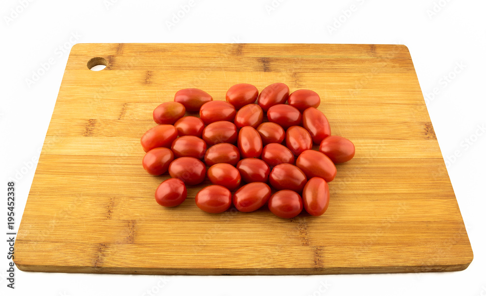 Cherry tomato on wooden board and white background Cherry tomato on wooden board and white background
