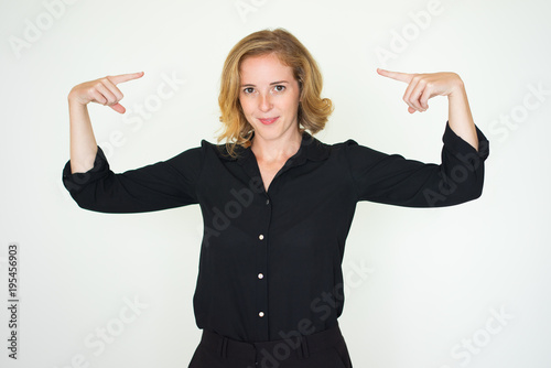 Positive successful woman pointing at herself photo