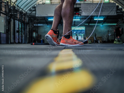 sportsman after Crossfit workout with rope on a dark background © shellygraphy