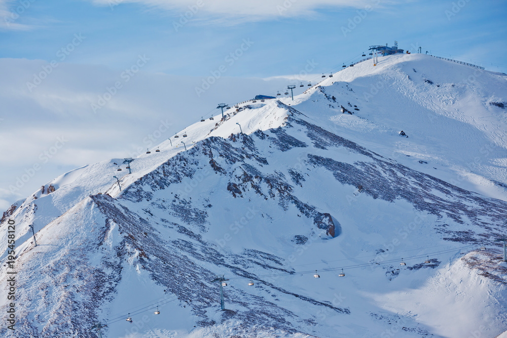 Ski elevator with skiers at ski resort