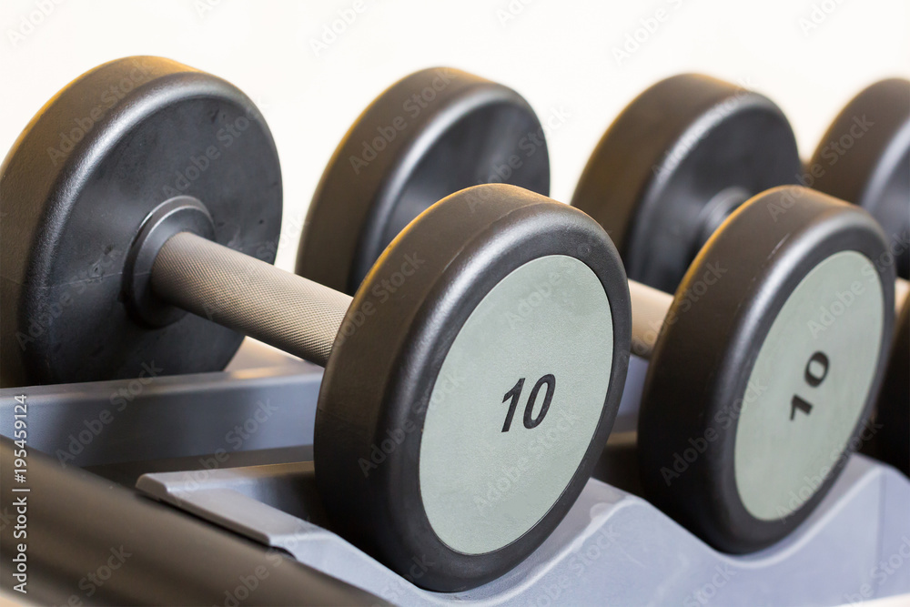dumbbells on steel rack in weight training centre