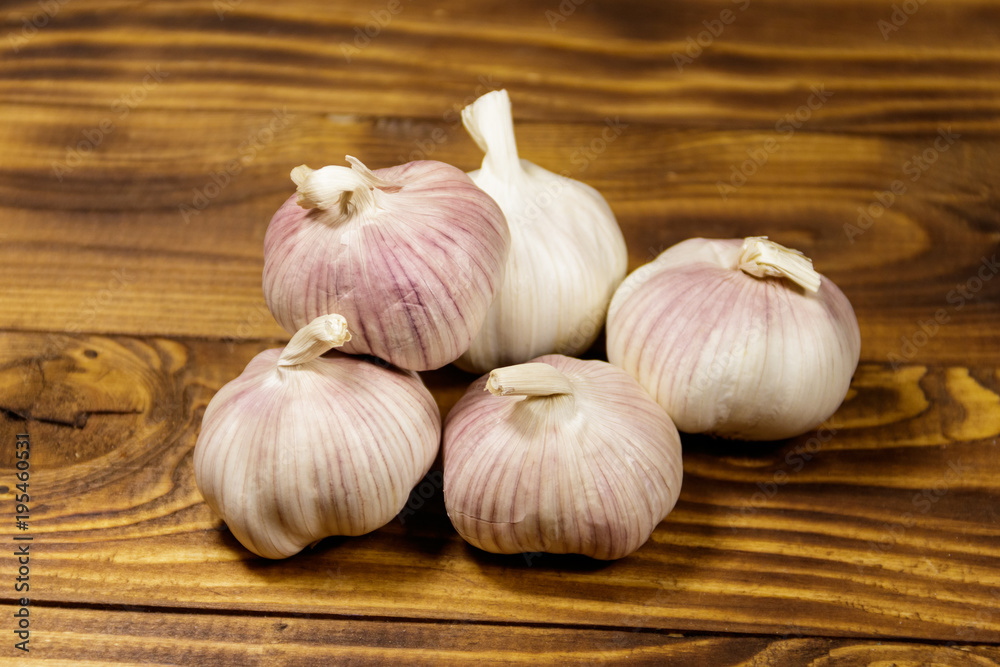 Bulbs of garlic on wooden table