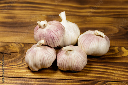 Bulbs of garlic on wooden table