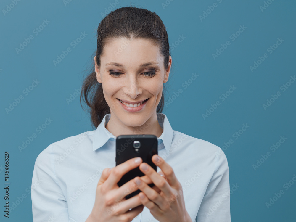 Smiling woman connecting with her smartphone Smiling woman connecting with her smartphone