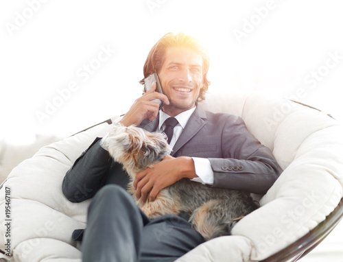 business man talking on the phone and holding his pet