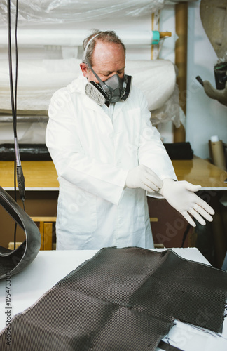  59  year  old man working at the fiber workshop photo