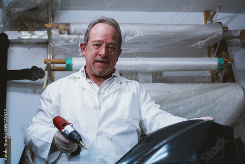  59  year  old man working at the fiber workshop photo