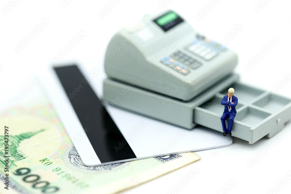 Miniature people: businessman sitting on calculator using as background Financial and business concept. Miniature people: businessman sitting on calculator using as background Financial and business concept.