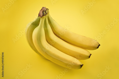 Banana stock images. Banana on a yellow background. Bunch of ripe bananas