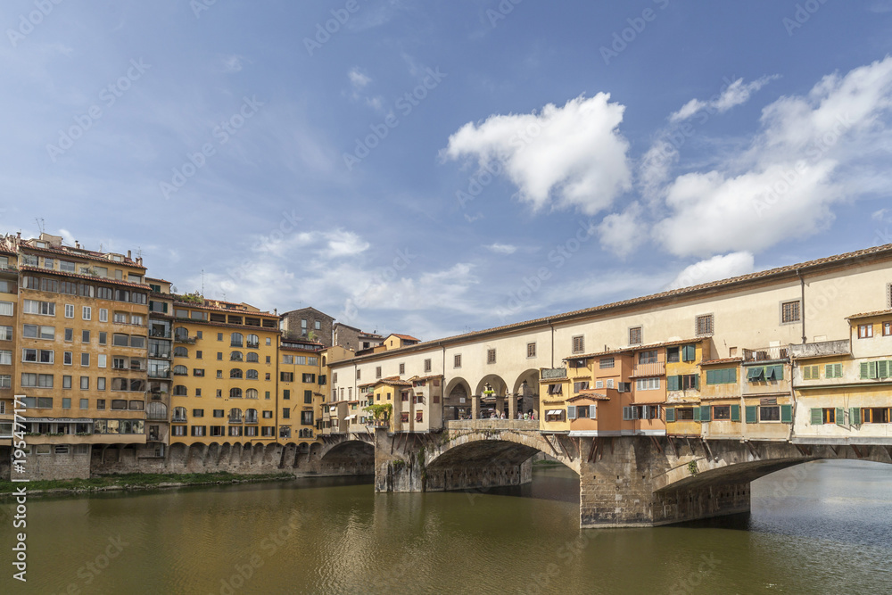 Iconic monument, bridge, Ponte Vecchio, medieval stone construction over Arno river. Tuscany, Italy.