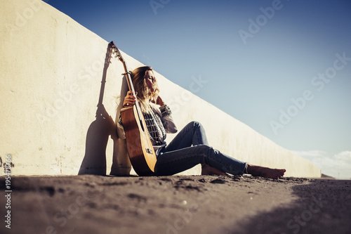 rebel vagabond beautiful young woman with guitar