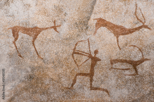 An image of an ancient man's hunting on the wall of a cave. ancient world history.