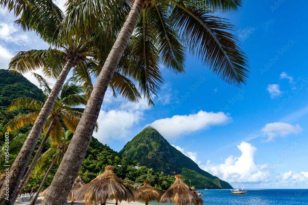Gros Piton, with palm trees and thatched sun umbrellas, Sugar Beach, St. Lucia, Windward Islands Caribbean