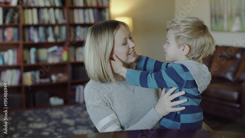 Beautiful young mother kissing her baby boy