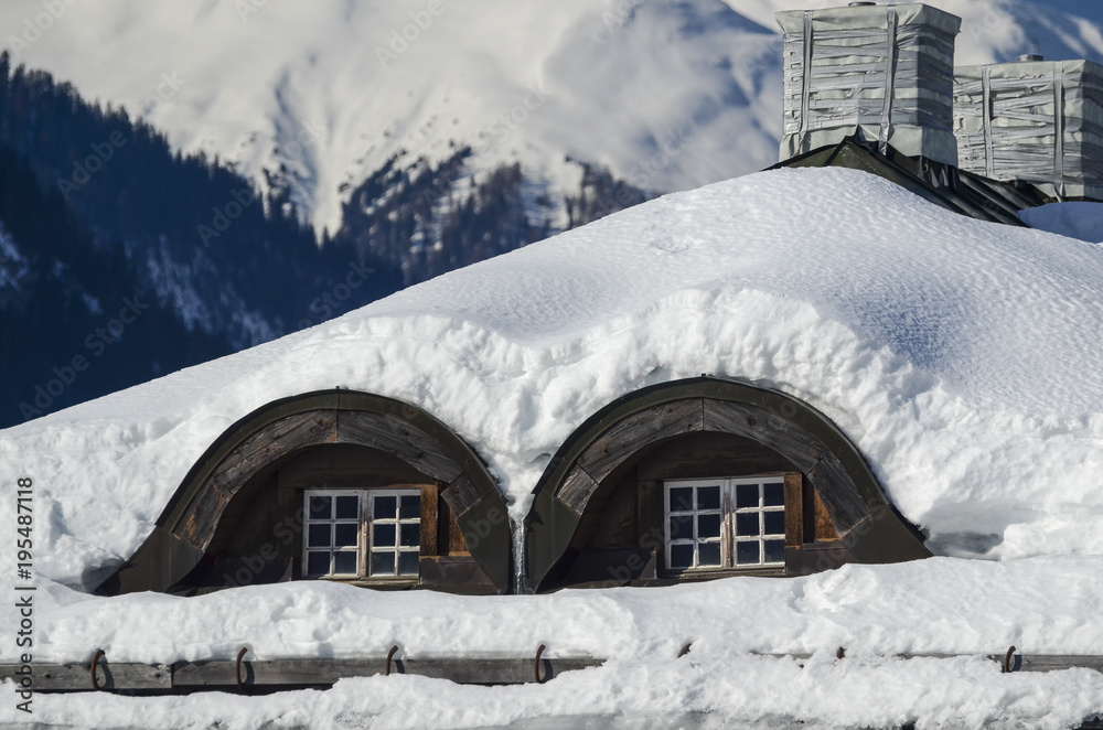 Fototapeta premium Small attic windows. Alps background