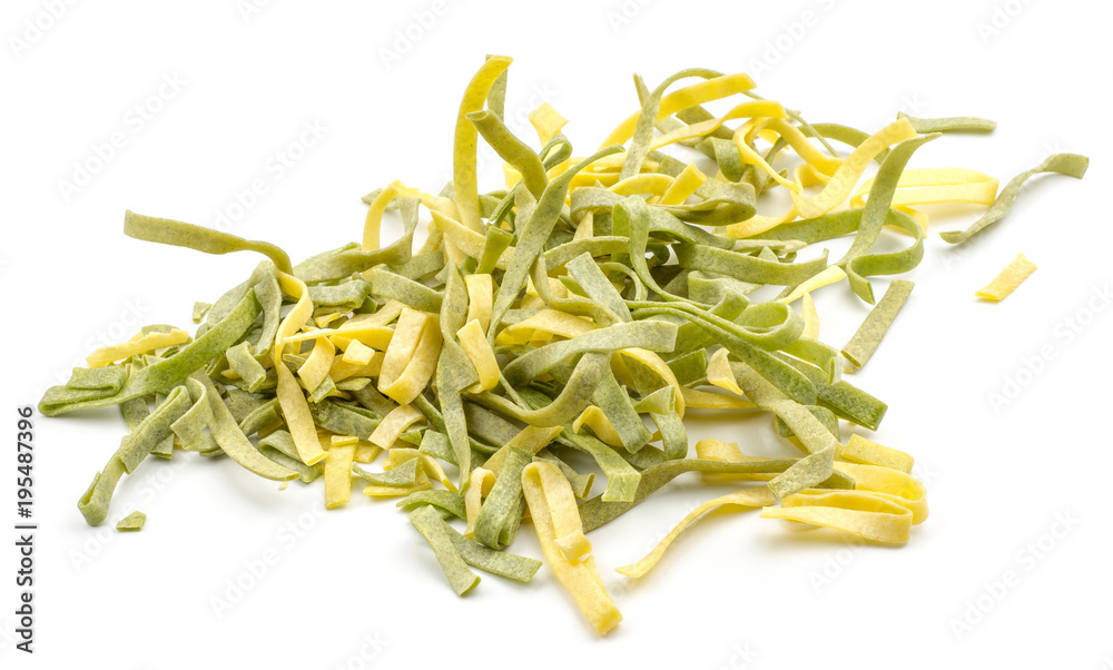 Fettuccine pasta classic and spinach pieces stack raw isolated on white background. Fettuccine pasta classic and spinach pieces stack raw isolated on white background.