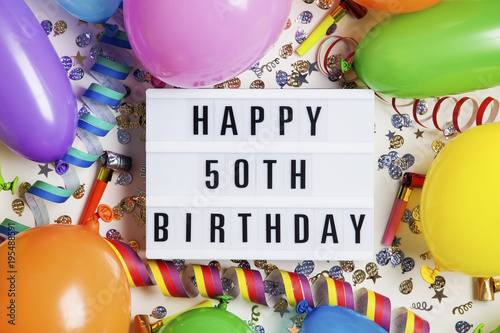 Canvas Print Happy 50th birthday celebration message on a lightbox with balloons and confetti