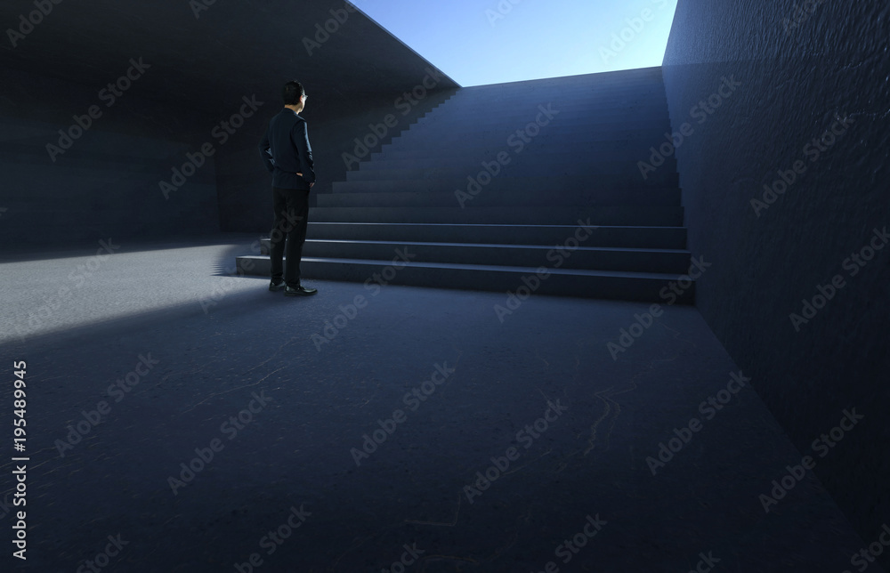 Businessman looking and thinking front of a concrete stairs in the underground .