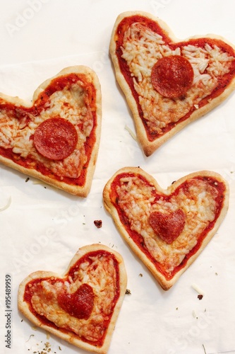 Homemade Mini Pizza hearts on white background, top view
