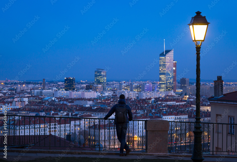 Man looking over the 6e arrondissement  from a park in Croix Rousse. Lyon, France. - obrazy, fototapety, plakaty 