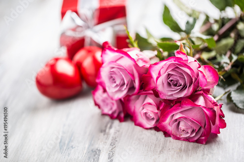 Roses. Pink roses with two hearts and red gift.