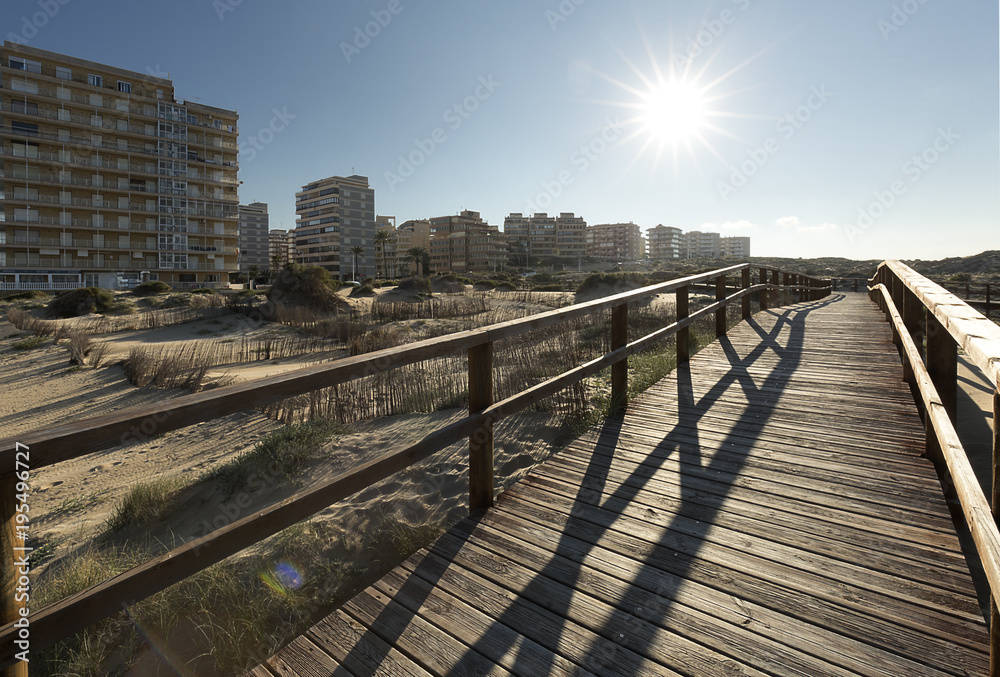 Backlight on a wooden footbridge in Arenales del Sol.