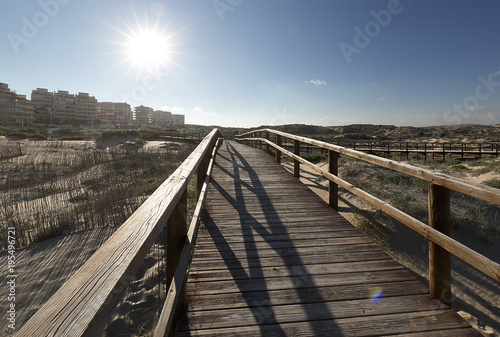 Backlight on a wooden footbridge in Arenales del Sol.