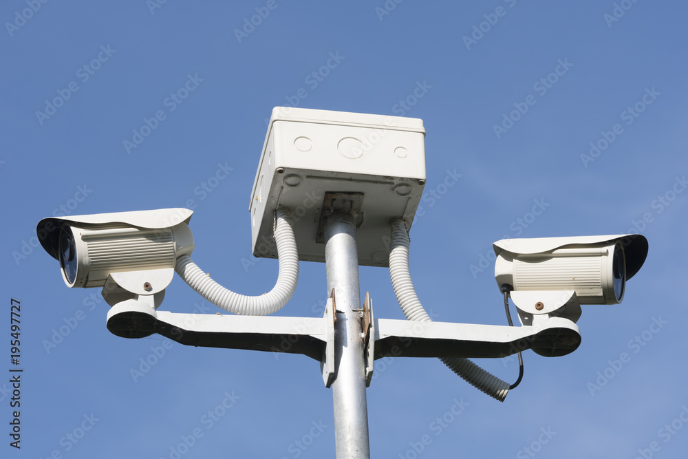 cctv security camera on blue background, property protection