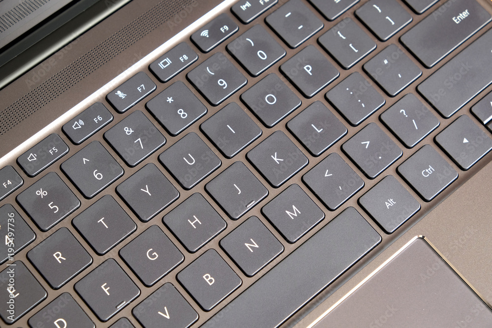 Part of laptop keyboard and touchpad of black opened laptop top view closeup Part of laptop keyboard and touchpad of black opened laptop top view closeup