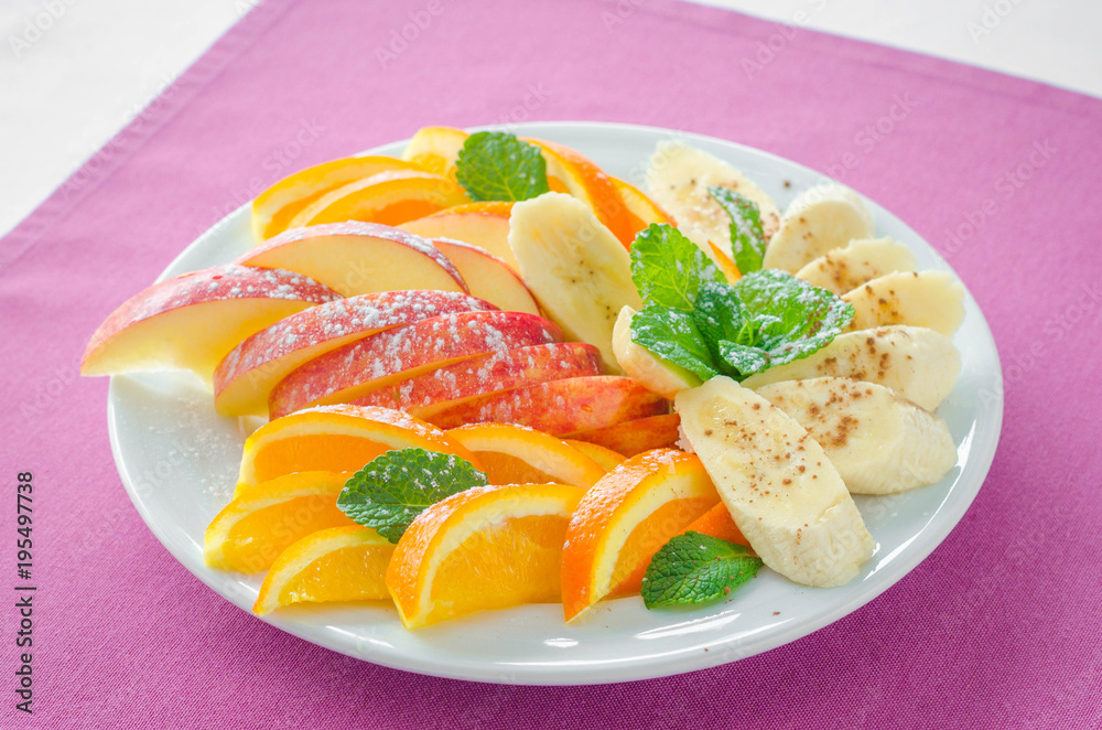 Bananas, apples , pineapple, oranges. Assorted fruits on the plate with pink background. Flat lay. Vegan. Healthy food concept. Bananas, apples , pineapple, oranges. Assorted fruits on the plate with pink background. Flat lay. Vegan. Healthy food concept.