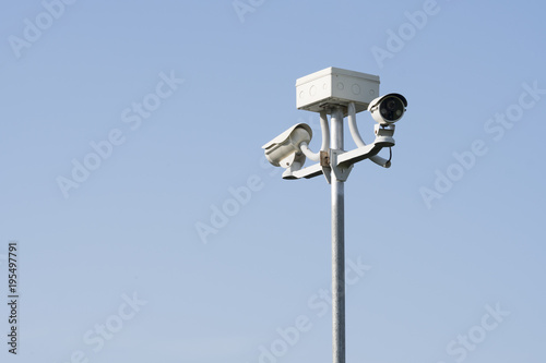 Outdoor CCTV Camera Operating for security in garden , on blue sky background