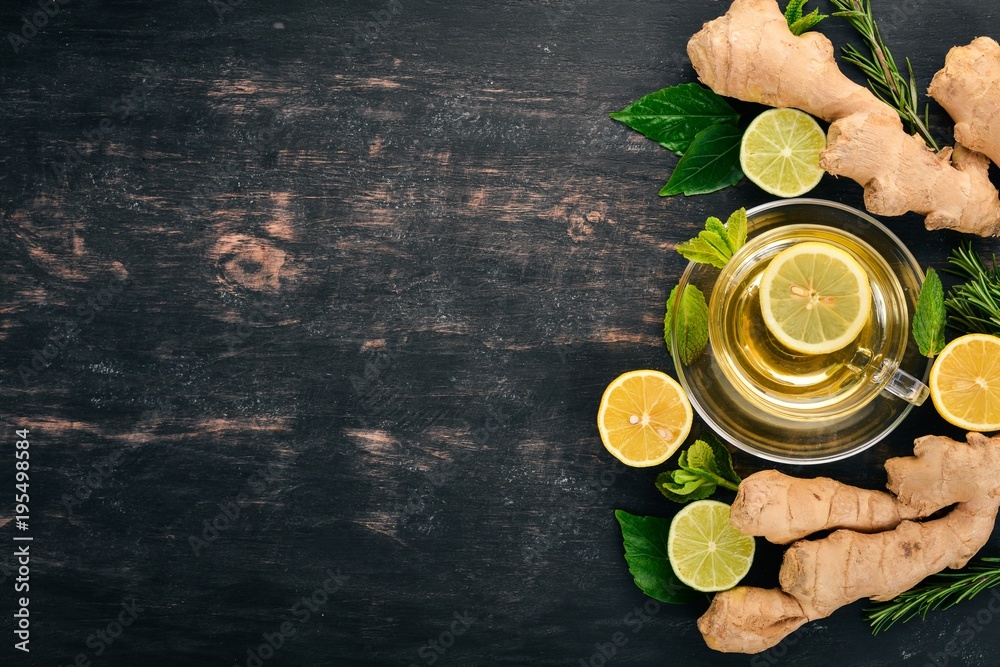 Tea with mint, ginger and lemon. Hot drink On a wooden background. Top view. Copy space. Tea with mint, ginger and lemon. Hot drink On a wooden background. Top view. Copy space.