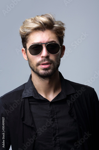 Close-up portrait of handsome stylish man in sunglasses. © ASDF