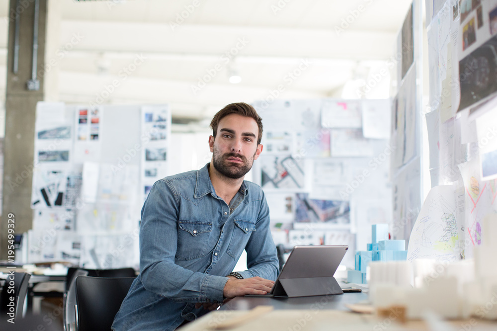 Portrait of young businessman working in office Portrait of young businessman working in office
