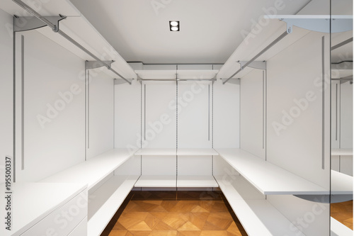 Large white walk-in closet with parquet