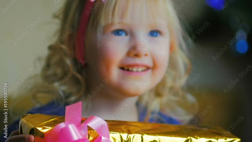 Close up Of A Three year old Girl Jumping For Joy Near A Christmas Tree close-up-of-a-three-year-old-girl-jumping-for-joy-near-a-christmas-tree