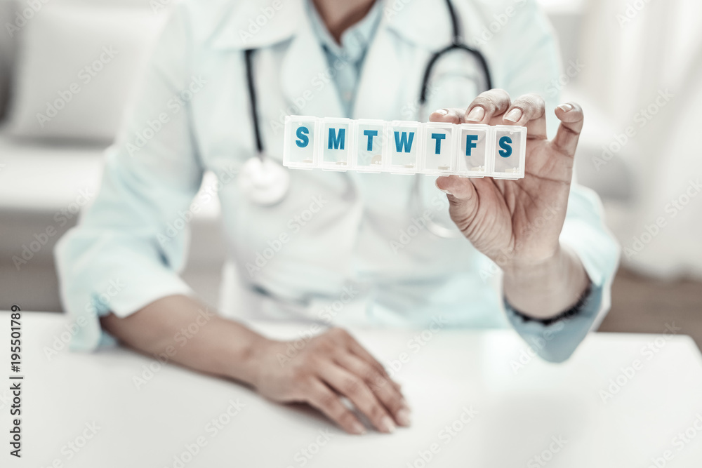Take it. Mature experienced reliable nurse showing and suggesting pills holding it in left hand. Take it. Mature experienced reliable nurse showing and suggesting pills holding it in left hand.
