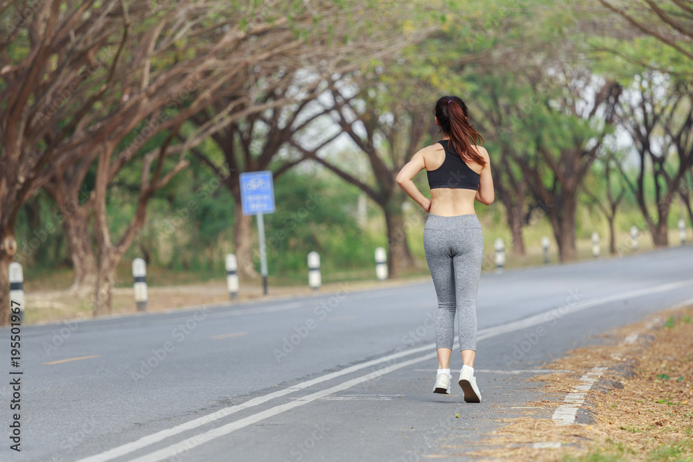 young fitness woman running in park young fitness woman running in park
