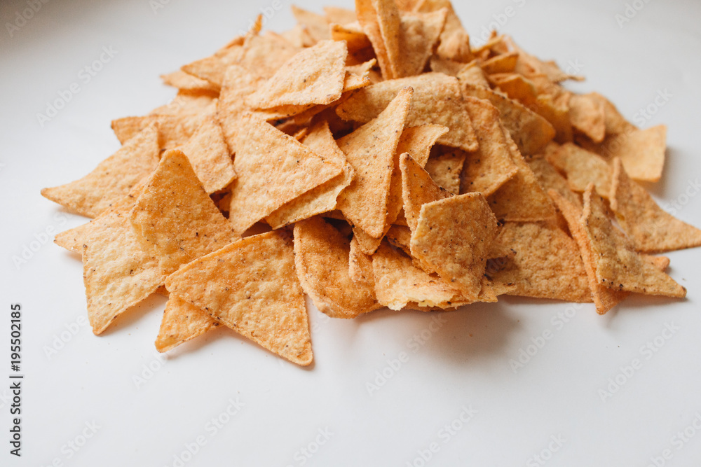 pile of delicious crispy nachos on white background, traditional Mexican cuisine pile of delicious crispy nachos on white background, traditional Mexican cuisine