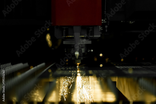 CNC laser cutting metal sheet with bright sparkle