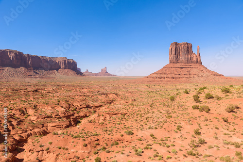 Scenic Drive on Dirt Road through Monument Valley, The famous Buttes of Navajo tribal Park, Utah - Arizona, USA. Scenic road and red rock formations.