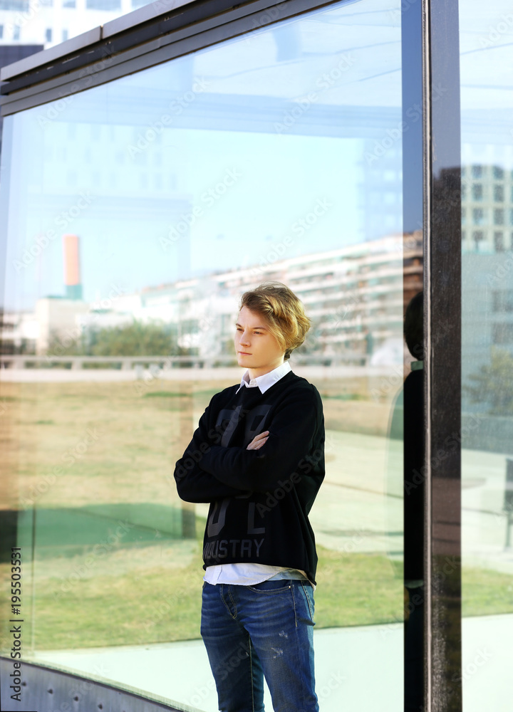 Attractive teenage boy in urban background Attractive teenage boy in urban background
