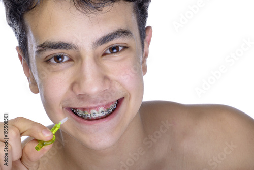 Teen boy wearing braces on white background